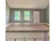 New kitchen island with granite countertop and grey cabinets gives a homey and simple yet modern vibe at 201 Deerfield Ln, Carrollton, GA 30116