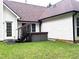 Outdoor hot tub and staircase in a backyard featuring traditional siding and lush green grass at 300 Gaelic Way, Tyrone, GA 30290