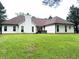 Spacious backyard with a well-maintained lawn and back of home with traditional siding at 300 Gaelic Way, Tyrone, GA 30290