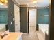 A classic bathroom featuring a bathtub, sink with traditional fixtures, and vintage wallpaper at 300 Gaelic Way, Tyrone, GA 30290