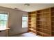 A well-lit room with built-in bookshelves and large windows at 300 Gaelic Way, Tyrone, GA 30290
