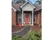 Inviting entrance with a decorative wreath, sidelight windows, and manicured garden beds at 300 Gaelic Way, Tyrone, GA 30290
