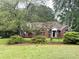 Traditional brick home on a landscaped lot with mature trees and a well-maintained lawn at 300 Gaelic Way, Tyrone, GA 30290