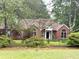 Charming brick home with a well-manicured lawn and beautiful landscaping at 300 Gaelic Way, Tyrone, GA 30290