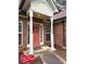 Welcoming brick home featuring a covered entryway and lovely front door wreath at 300 Gaelic Way, Tyrone, GA 30290