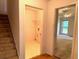 Hallway with staircase, laundry room, and opening to living room at 300 Gaelic Way, Tyrone, GA 30290