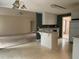 Bright kitchen with white cabinets and tile flooring, open to the carpeted living room at 300 Gaelic Way, Tyrone, GA 30290