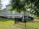 Backyard view showcasing the fenced yard, grassy area and exterior of the home with multiple windows at 312 Archway Ln, Peachtree City, GA 30269