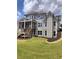 Spacious backyard featuring a two-story deck, lush lawn, and tasteful landscaping at 312 Archway Ln, Peachtree City, GA 30269
