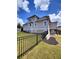 Spacious backyard with black metal fence, lush green grass, and retaining wall at 312 Archway Ln, Peachtree City, GA 30269