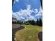 Well-maintained backyard featuring lush green grass, retaining wall, and landscaping at 312 Archway Ln, Peachtree City, GA 30269