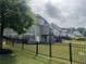 Backyard showing the fence and well-maintained lawn surrounding the property, with neighboring houses in view at 312 Archway Ln, Peachtree City, GA 30269