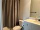Clean bathroom featuring a shower with curtain, toilet, and vanity with a white countertop at 312 Archway Ln, Peachtree City, GA 30269