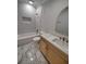 Bright bathroom featuring marble floors, white tiled walls, a tub, and a wooden vanity at 312 Archway Ln, Peachtree City, GA 30269