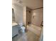 Bright bathroom features a shower-tub, tile floor, and a white vanity at 312 Archway Ln, Peachtree City, GA 30269
