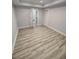 A spacious bedroom with hardwood floors, white trim, and two white doors at 312 Archway Ln, Peachtree City, GA 30269