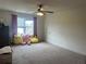 Spacious bedroom with a ceiling fan, window, and carpeted flooring at 312 Archway Ln, Peachtree City, GA 30269