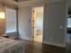 Bedroom with hard wood floors, bright window, and a bathroom nearby at 312 Archway Ln, Peachtree City, GA 30269