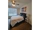 Cozy bedroom featuring hardwood floors, a ceiling fan, and neutral decor at 312 Archway Ln, Peachtree City, GA 30269