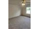 Large carpeted bedroom features a ceiling fan, large window, and custom wallpaper at 312 Archway Ln, Peachtree City, GA 30269