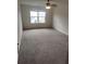 Spacious bedroom with a large window and ceiling fan is carpeted for comfort at 312 Archway Ln, Peachtree City, GA 30269