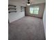 Spare carpeted bedroom featuring a window, ceiling fan, and walk in closet at 312 Archway Ln, Peachtree City, GA 30269