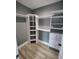 Walk-in closet featuring custom shelving, storage space, and hardwood floors at 312 Archway Ln, Peachtree City, GA 30269