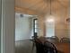 Dining room with a long wooden table, decorative chandelier and hardwood floors at 312 Archway Ln, Peachtree City, GA 30269