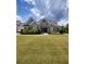 Charming two-story home with well-manicured lawn and beautiful landscaping at 312 Archway Ln, Peachtree City, GA 30269
