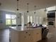 Bright open kitchen with modern island, stainless appliances, and adjacent living space at 312 Archway Ln, Peachtree City, GA 30269