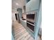 The kitchen has modern stainless steel appliances and blue custom cabinetry at 312 Archway Ln, Peachtree City, GA 30269