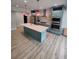 Modern kitchen with light blue cabinets, stainless steel appliances, and an island with a white countertop at 312 Archway Ln, Peachtree City, GA 30269