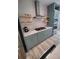 Modern kitchen with stainless steel appliances, floating shelves, and plenty of storage at 312 Archway Ln, Peachtree City, GA 30269