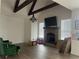 Bright living room with a brick fireplace and vaulted ceilings with dark wood beams at 312 Archway Ln, Peachtree City, GA 30269
