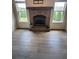 Cozy living room boasts hardwood floors, brick fireplace and lots of natural light at 312 Archway Ln, Peachtree City, GA 30269