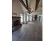 Open floor plan living room featuring a brick fireplace and beams in the vaulted ceiling at 312 Archway Ln, Peachtree City, GA 30269