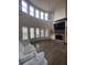 Open living room with hardwood floors, fireplace, large windows, and high ceilings at 312 Archway Ln, Peachtree City, GA 30269