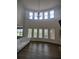 Bright living room with hardwood floors, a fireplace, and a large curved window array at 312 Archway Ln, Peachtree City, GA 30269