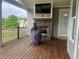Relaxing covered patio features a stone fireplace with TV and outdoor grill, a perfect space for gatherings at 312 Archway Ln, Peachtree City, GA 30269