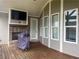 Covered outdoor patio featuring a stone fireplace, TV, and grill, perfect for entertaining at 312 Archway Ln, Peachtree City, GA 30269