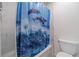 Well lit bathroom with shower-tub combination featuring a nautical themed shower curtain at 4367 Cedar Wood Sw Dr, Lilburn, GA 30047