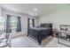 Comfortable bedroom with natural light from two windows with dark curtains and neutral walls and carpet at 4367 Cedar Wood Sw Dr, Lilburn, GA 30047