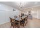 Cozy dining room featuring wood table and an elegant chandelier that opens to the kitchen at 4367 Cedar Wood Sw Dr, Lilburn, GA 30047