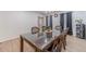 Bright dining area with a wood table, seating for six, and stylish window curtains at 4367 Cedar Wood Sw Dr, Lilburn, GA 30047
