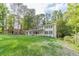 Well-manicured lawn surrounds this lovely two-story home with classic architectural details at 4367 Cedar Wood Sw Dr, Lilburn, GA 30047