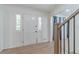 Bright foyer with wood-look floors, a modern staircase, and a view into the living space at 4367 Cedar Wood Sw Dr, Lilburn, GA 30047