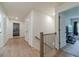 Hallway with wood floors leading to bedrooms and bathrooms with a modern staircase at 4367 Cedar Wood Sw Dr, Lilburn, GA 30047