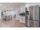 Modern kitchen with stainless steel refrigerator, white cabinets, and island at 4367 Cedar Wood Sw Dr, Lilburn, GA 30047