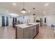 Open kitchen with an island, stainless steel appliances, and dining area with elegant chandelier at 4367 Cedar Wood Sw Dr, Lilburn, GA 30047