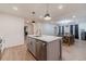 This renovated kitchen features an island with a quartz countertop, and stainless steel appliances at 4367 Cedar Wood Sw Dr, Lilburn, GA 30047